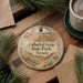 A decorative ornament with the text "Cathedral Gorge State Park, Nevada" on it, surrounded by pine branches and a cup of coffee on a wooden surface.