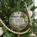 A round ornament hanging on a Christmas tree, featuring a scenic image of Cayuga Lake State Park in New York.