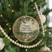 A round ornament hanging on a Christmas tree, featuring a scenic image of Cheeraw State Park, South Carolina.