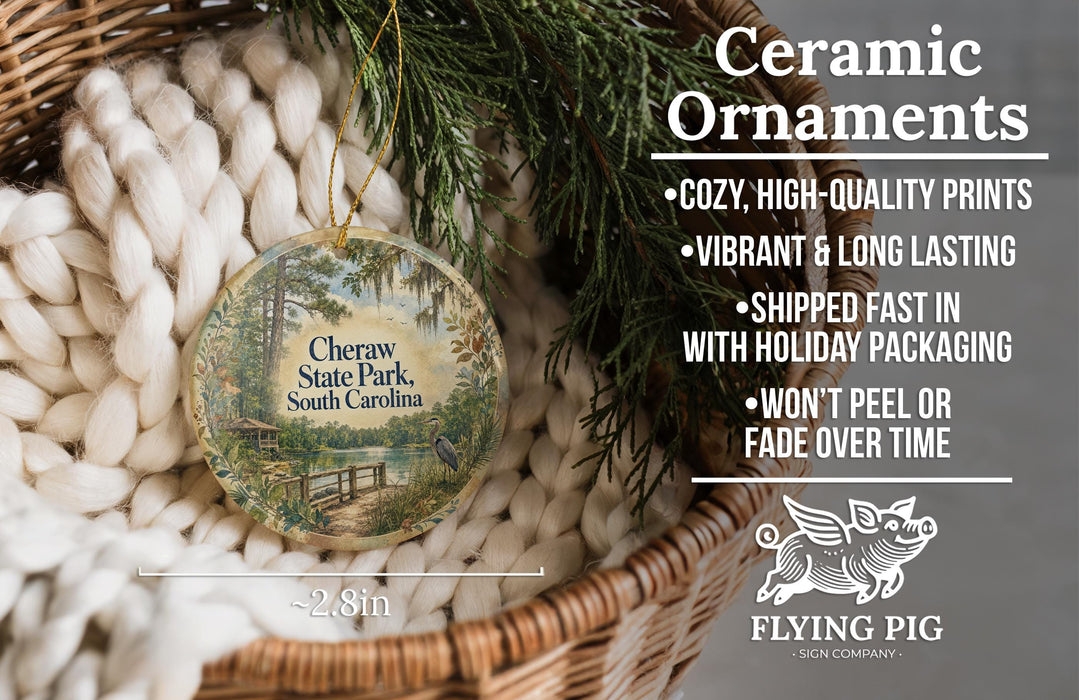 Ceramic ornaments, featuring a round ornament with a scenic view of Cheraw State Park, South Carolina, hanging from a wicker basket.