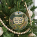A round ornament hanging on a Christmas tree, featuring a scenic image of Cherry Plain State Park in New York.