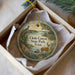 A decorative ornament in a box, featuring a scenic landscape with a bird, deer, and water, along with the text "Choke Canyon State Park, Texas".