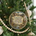A round ornament hanging on a Christmas tree, featuring a scenic image of Cimarron Canyon State Park in New Mexico.