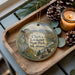 A wooden tray with a decorative ornament featuring a scenic landscape of Clark's Lookout State Park, Montana, and a mountain goat.