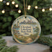 A circular ornament featuring a scenic view of Cleveland Lakefront State Park, Ohio, with a lighthouse and a sailboat in the background.