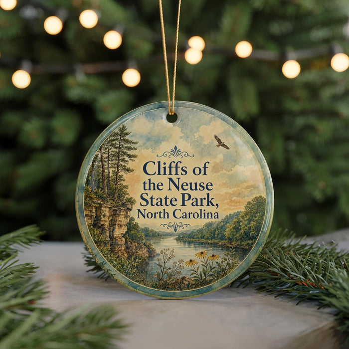 A round ornament with a scenic landscape of cliffs, trees, and a river, featuring the text "Cliffs of the Neuse State Park, North Carolina".