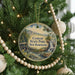 A round ornament hanging on a Christmas tree, featuring a scenic image of Clough State Park in New Hampshire.
