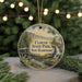 A round ornament with a scenic image of Clough State Park in New Hampshire, featuring a waterfall and a wooden bridge.
