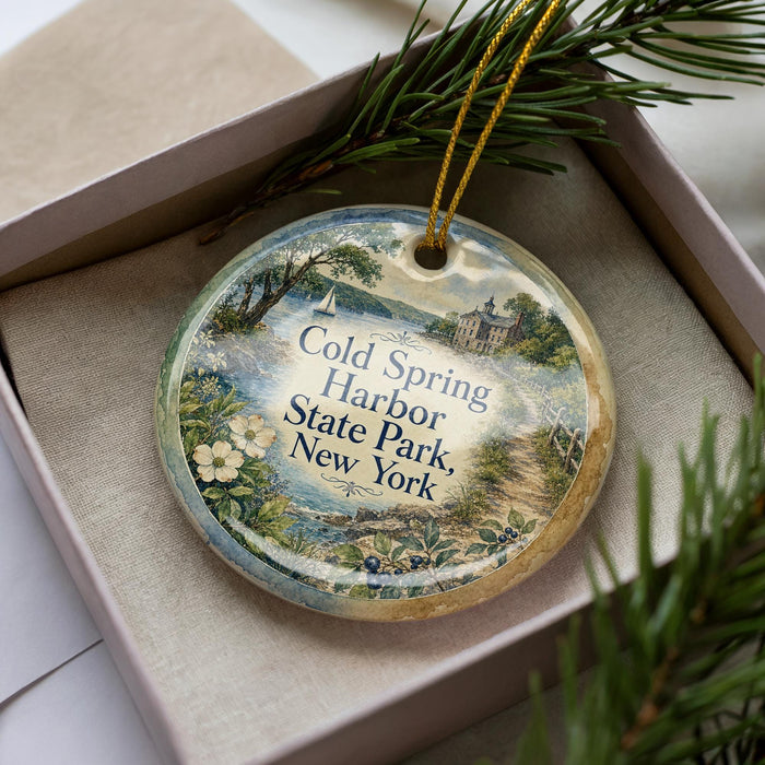 A decorative ornament in a box, featuring a scenic image of Cold Harbor State Park in New York.