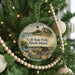 A round ornament hanging on a Christmas tree, featuring a scenic image of Colt State Park in Rhode Island.