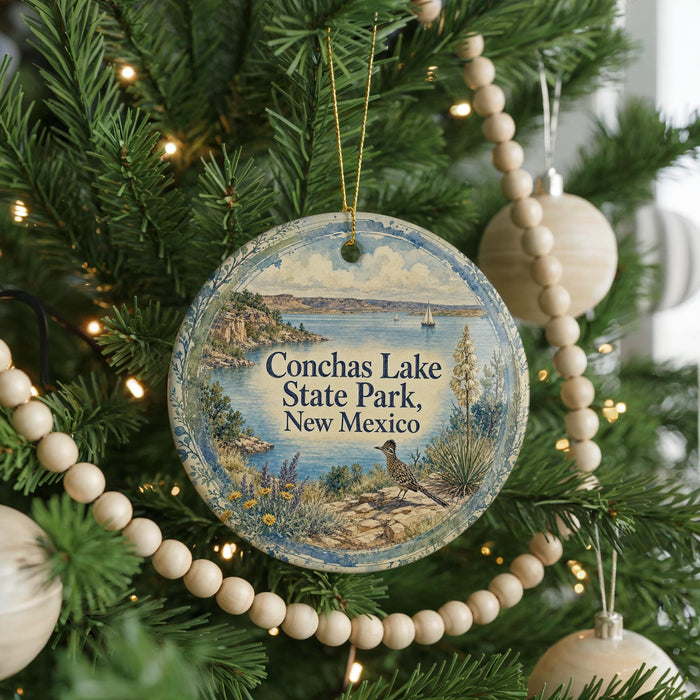 A round ornament hanging on a Christmas tree, featuring a scenic image of Conchas Lake State Park in New Mexico.