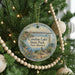 A round ornament hanging on a Christmas tree, featuring a scenic image of Conchas Lake State Park in New Mexico.