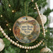 A Christmas tree decorated with ornaments, including a circular ornament with a scenic image of Copper Breaks State Park, Texas.