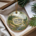 A decorative ornament with a scenic landscape of Cross Plains State Park, Wisconsin, featuring a winding path, pine trees, and a river.