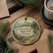 A round ornament with a scenic image of Crystal Lake State Park, Vermont, featuring a canoe on the lake and pine trees in the background.