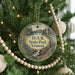 A round ornament on a Christmas tree, featuring a scenic landscape with a waterfall and a castle, with the text "D.A.R. State Park, Vermont" displayed on it.