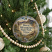 A round ornament hanging on a Christmas tree, featuring a scenic image of Davis Mountains State Park, Texas.