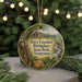 A circular ornament with a painting of Davy Crockett Birthplace State Park, Tennessee, featuring a rifle, a cabin, and a stream.