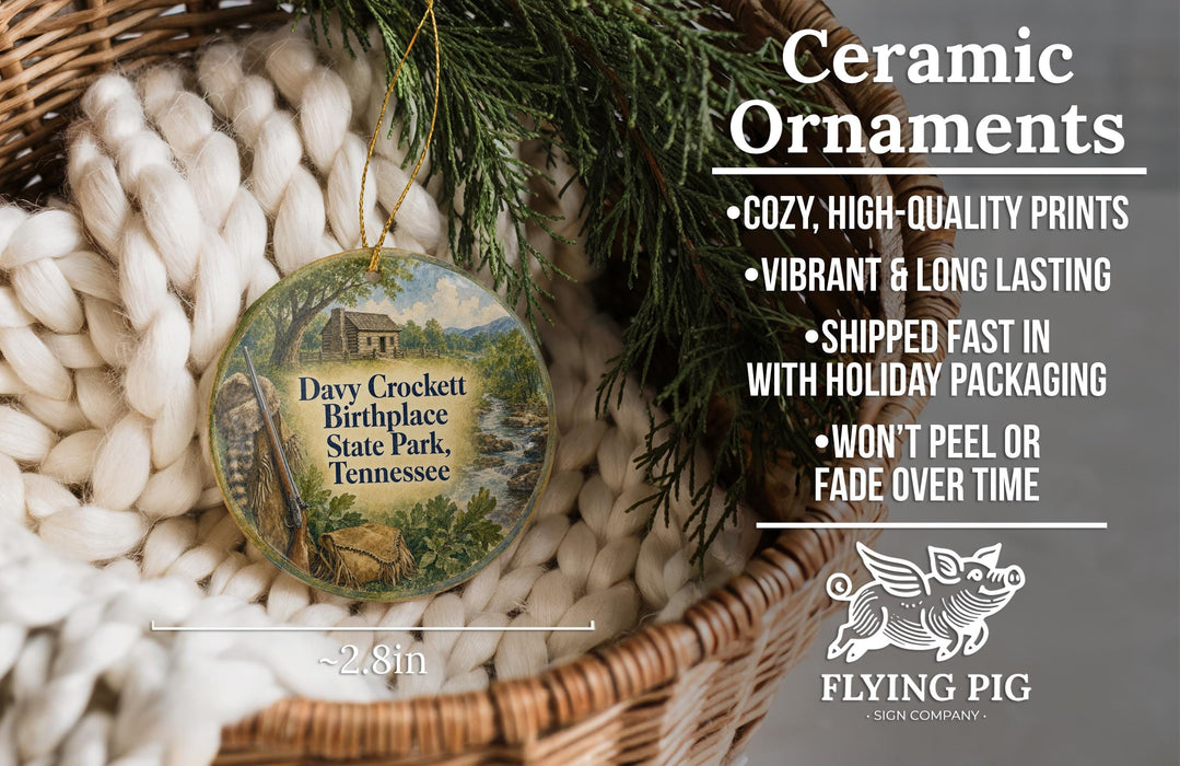 Ceramic ornaments, specifically a Dax Crockett Birthplace State Park, Tennessee ornament, are displayed in a woven basket. The ornament is described as cozy, high-quality prints, vibrant, and long-lasting, and it is shipped fast in holiday packaging. The ornament is not peeling or fading over time. The image also includes a scale for the ornament, indicating it is 2.8 inches in size.