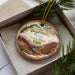 A decorative ornament with a scenic image of Dead Horse Point State Park in Utah, featuring a winding road and mountains in the background.
