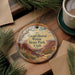 A decorative ornament with a scenic image of Dead Horse Point State Park in Utah, featuring a winding river and mountains in the background.