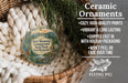 Ceramic ornaments, featuring a deer mountain campsite, are displayed in a basket with pine branches.