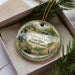 A decorative ornament in a box, featuring a scenic image of Delaware Canal State Park, Pennsylvania.