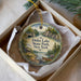 A decorative ornament in a box, featuring a scenic landscape with a lake, mountains, and a cabin, along with the text "Delta Lake State Park, New York".