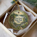A decorative ornament in a box, featuring a scenic landscape with a lake, a bird, and a house, along with the text "East Fork State Park, Ohio".