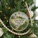 A round ornament on a Christmas tree, featuring a lighthouse and a coastal scene, with the text "East Harbor State Park, Ohio" displayed on it.