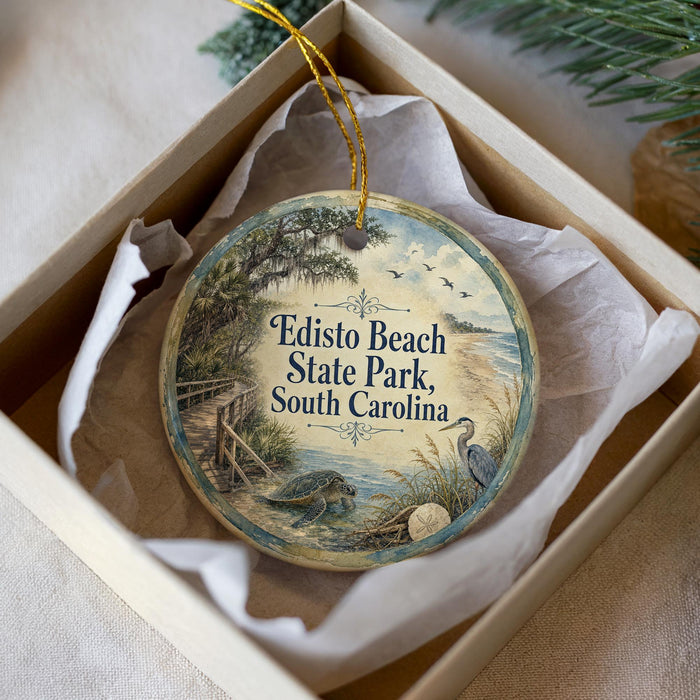 A round ornament with a scenic illustration of Edisto Beach State Park, South Carolina, hanging from a string.