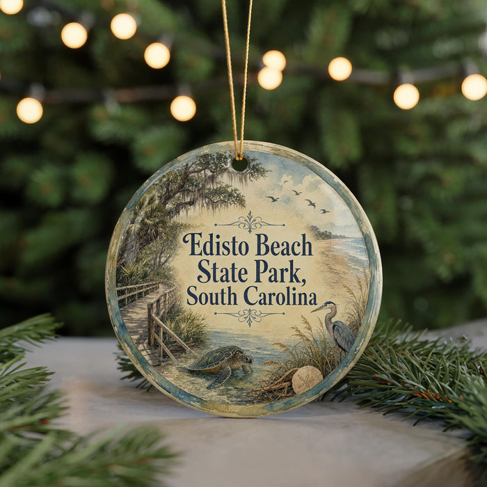 A round ornament with a scenic image of Edisto Beach State Park, South Carolina, featuring a bird, a turtle, and a path leading to the beach.