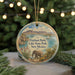 A circular ornament featuring an illustration of Elephant Butte Lake State Park in New Mexico, with a small elephant standing in the foreground and a scenic landscape in the background.