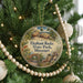 A round ornament hanging on a Christmas tree, featuring a scenic image of Elephant Rocks State Park, Missouri.