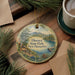 A decorative ornament featuring a scenic landscape of Ellacoya State Park in New Hampshire, with pine trees and a lake in the background.