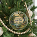 A Christmas tree decorated with ornaments, including a circular ornament with a scenic image of the state park in New York.
