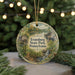 A round ornament with a scenic illustration of Pennsylvania State Park, featuring a house, trees, and a waterfall, is displayed in front of a blurred background with Christmas lights.