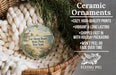 Ceramic ornaments, featuring a round ornament with a lighthouse and a seascape design, hanging from a wicker basket.