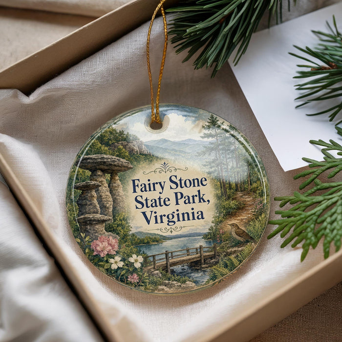 A decorative ornament with a scenic landscape of Fairy Stone State Park, Virginia, featuring a winding path, a bridge, and a body of water.