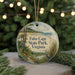 A round ornament with a scenic landscape of Cape State Park, Virginia, featuring a bird and a path leading to the beach.