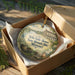 A decorative ornament in a wooden box, featuring an illustration of the historic state house in Missouri.