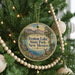 A round ornament hanging on a Christmas tree, featuring a scenic image of Fenton Lake State Park, New Mexico.