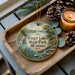 A decorative ornament featuring a scenic landscape of Finger Lakes State Park, Missouri, with pine cones and a lit candle on a wooden tray.