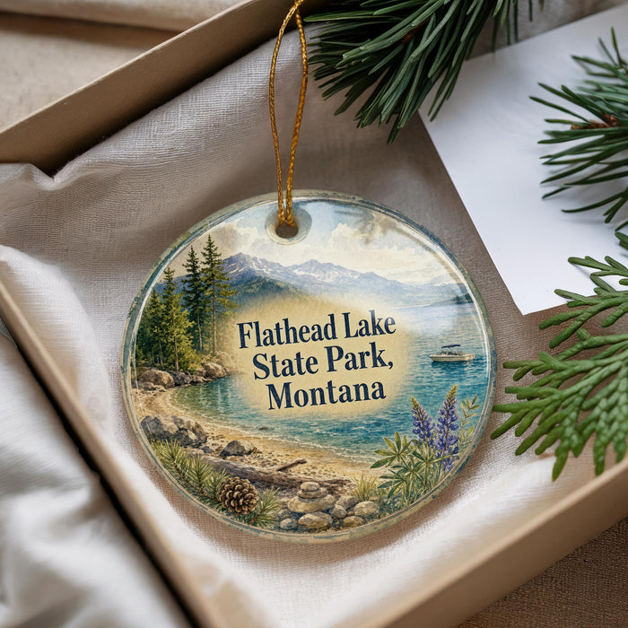A decorative ornament with a scenic image of Flathead Lake State Park, Montana, hanging from a string.