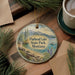A circular ornament with a scenic landscape of Flathead Lake, State Park, Montana, featuring pine trees, a lake, and mountains.