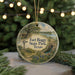 A round ornament with a scenic landscape of Fort Bogy State Park, Texas, featuring a windmill, a house, and a river.