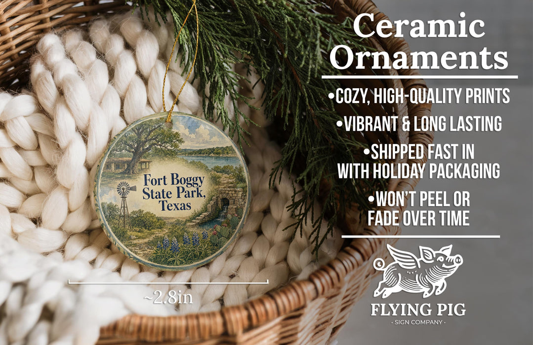 Ceramic ornaments, featuring a round ornament with a scenic view of Fort Bogy State Park, Texas, hanging from a wicker basket.