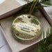 A decorative ornament with a picture of Fort Davidson State Historic Site in Missouri, featuring a building, trees, and a flag.