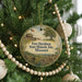 A round ornament hanging on a Christmas tree, featuring an illustration of Fort Davidson State Historic Site in Missouri.