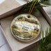 A decorative ornament in a box, featuring an illustration of Fort Griffin, the historic site in Texas.